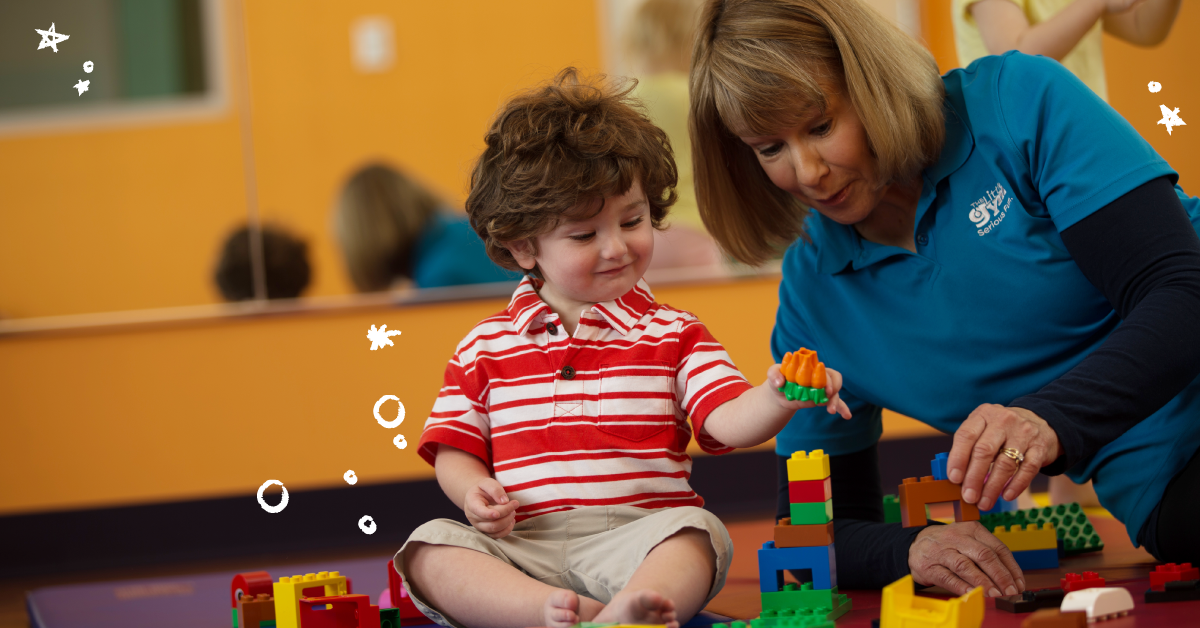 fran-dev-large-6 boy building blocks with a little gym instructor